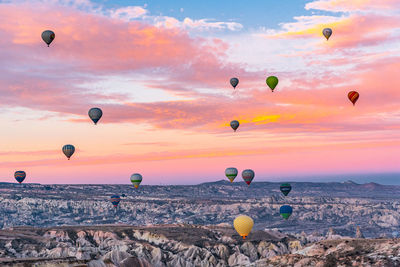 Hot air balloons flying in sky during sunset