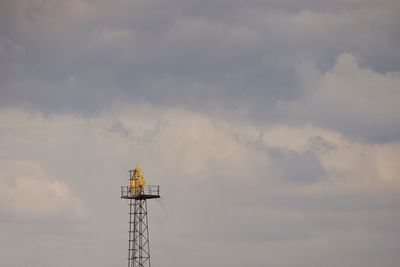 Low angle view of communications tower against sky