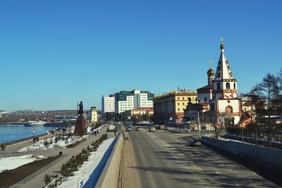 Epiphany cathedral by road against clear blue sky in city