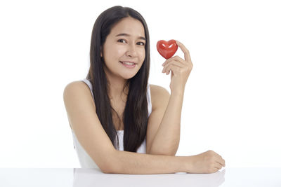 Portrait of a smiling young woman over white background