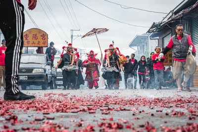 People standing on street against sky