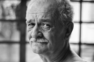 Close-up portrait of smiling man looking away