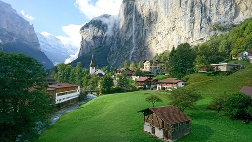 Panoramic view of houses and mountains against sky