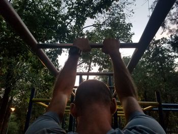 Low angle view of man playing in playground