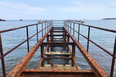 Pier over sea against sky