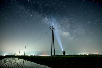 Low angle view of windmill against sky at night