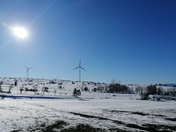 Scenic view of snowcapped landscape against clear blue sky