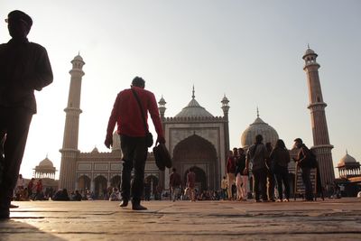People at temple against clear sky
