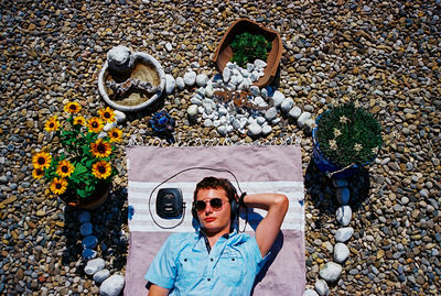 Portrait of young woman standing by plants