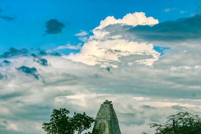 Low angle view of trees and buildings against sky