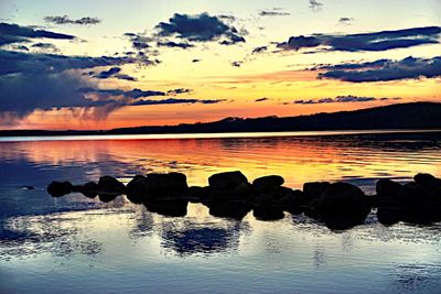 Scenic view of lake against sky during sunset