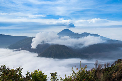 View of volcanic landscape against cloudy sky