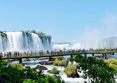 People at tourist resort against clear sky