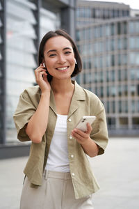 Portrait of young businesswoman using mobile phone