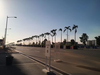 Empty road against clear blue sky