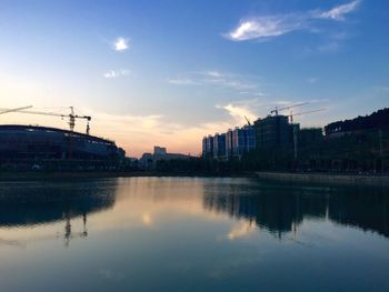 Reflection of buildings in river at sunset