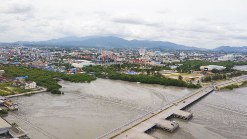 High angle view of townscape by road against sky