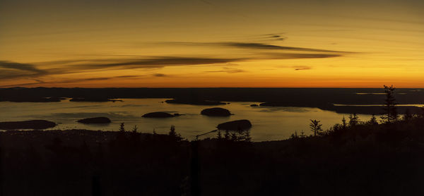 Scenic view of lake against orange sky