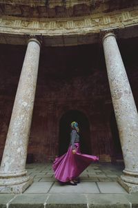 Woman spinning amidst columns at alhambra