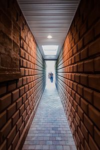 Rear view of people walking on footpath