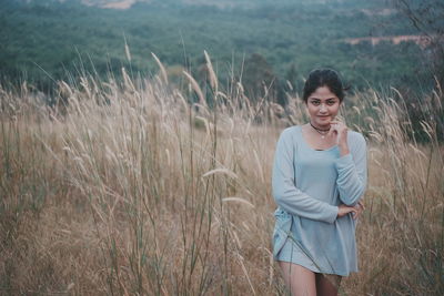 Young woman standing on field