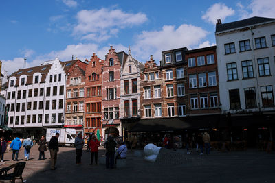 People in city against sky