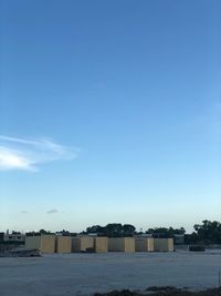 Buildings on beach against clear blue sky