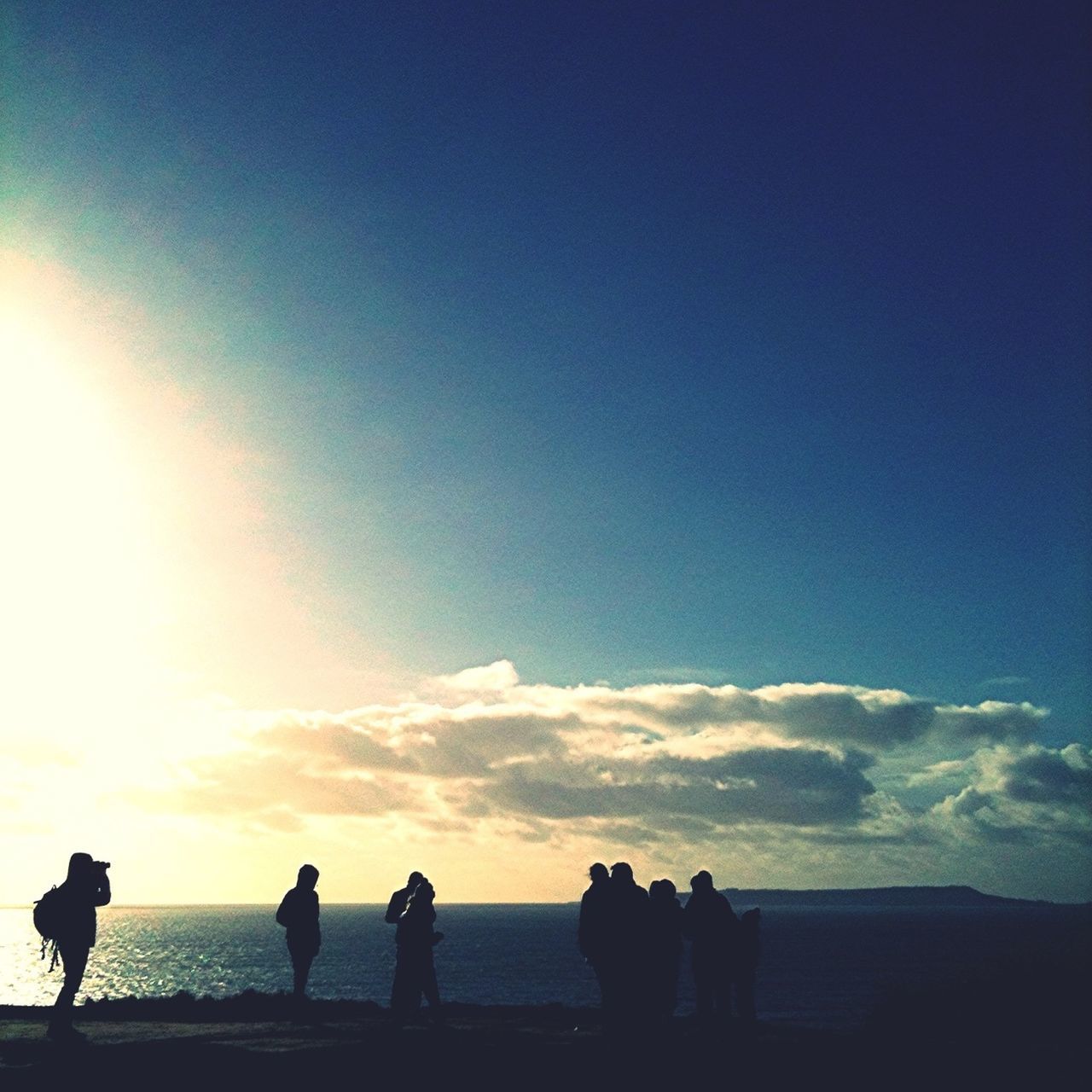 silhouette, sunset, sea, sky, water, horizon over water, men, scenics, tranquility, standing, beauty in nature, togetherness, tranquil scene, nature, blue, beach, person, lifestyles