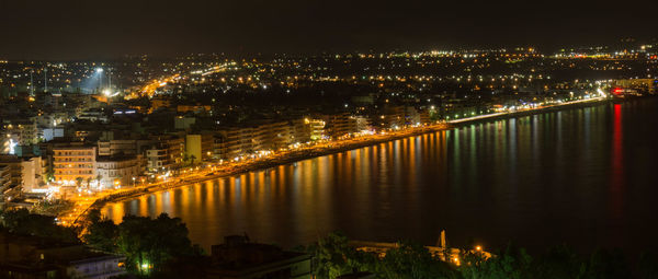 Illuminated city at waterfront