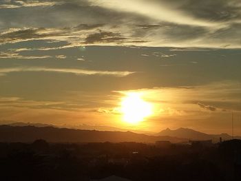 Scenic view of silhouette mountains against sky at sunset