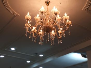 Low angle view of illuminated light bulbs hanging from ceiling