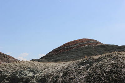 Low angle view of mountain against blue sky