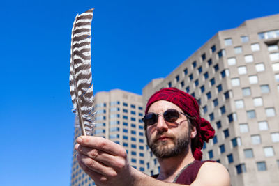 Portrait of man wearing sunglasses against sky