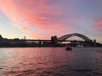View of bridge over river against cloudy sky