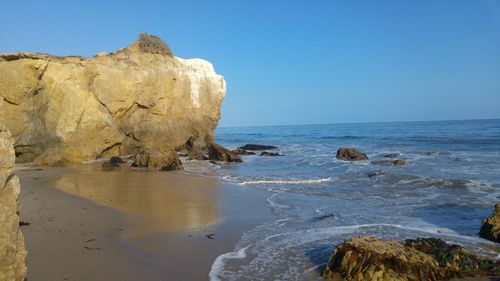 Scenic view of sea against clear blue sky