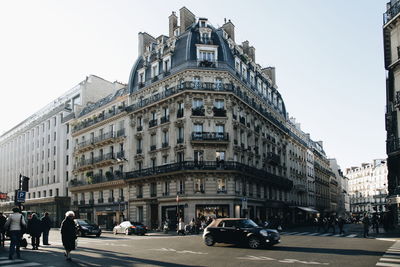 View of city street and buildings against sky