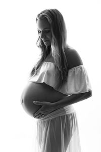 Young woman standing against white background