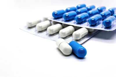 High angle view of blue buttons on table against white background