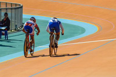 Rear view of people with bicycle