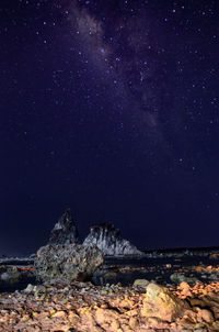 Scenic view of mountains against sky at night