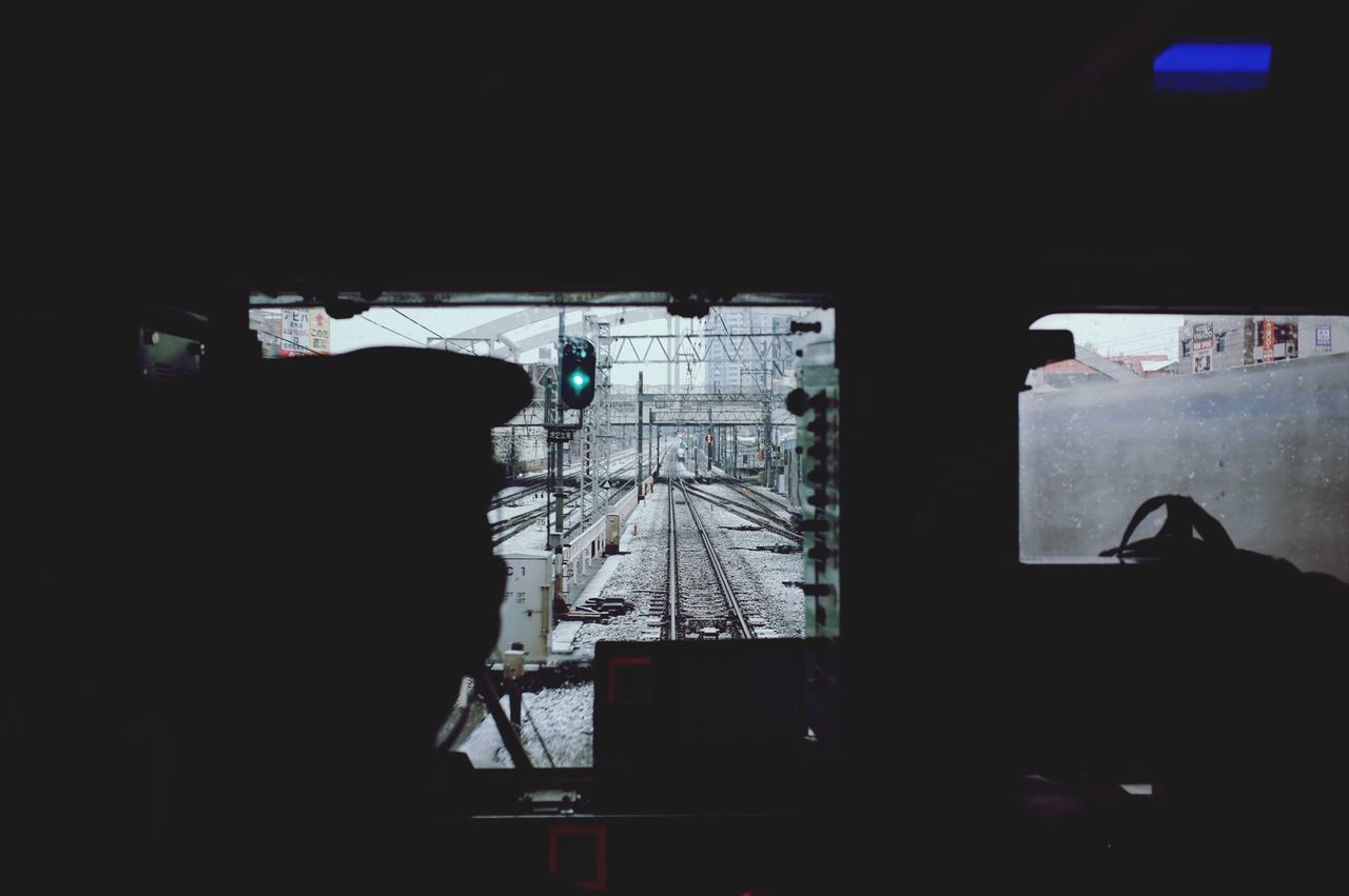 indoors, window, built structure, architecture, glass - material, transportation, transparent, silhouette, mode of transport, dark, vehicle interior, building exterior, city, looking through window, public transportation, day, no people, travel, building, land vehicle