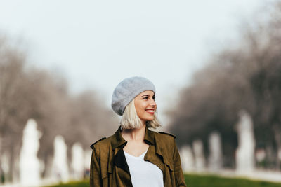 Portrait of young woman standing in snow