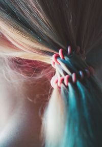 Close-up of woman hand on multi colored eye