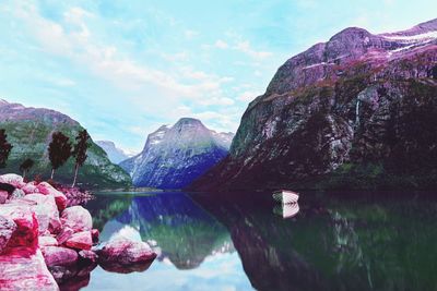 Scenic view of lake and mountains against sky