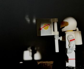 Close-up of toys on table against wall