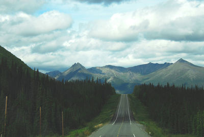 Road amidst mountains against sky