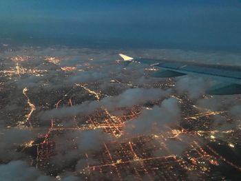 Aerial view of illuminated city against sky at night