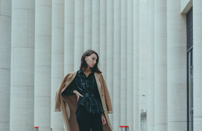 Woman standing against wall