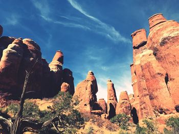 Low angle view of rock formations against sky