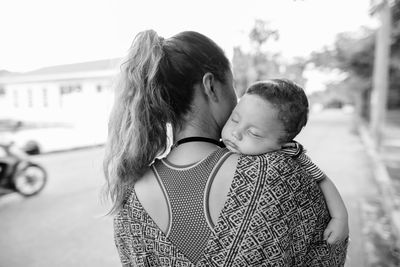 Rear vie of mother with son outdoors